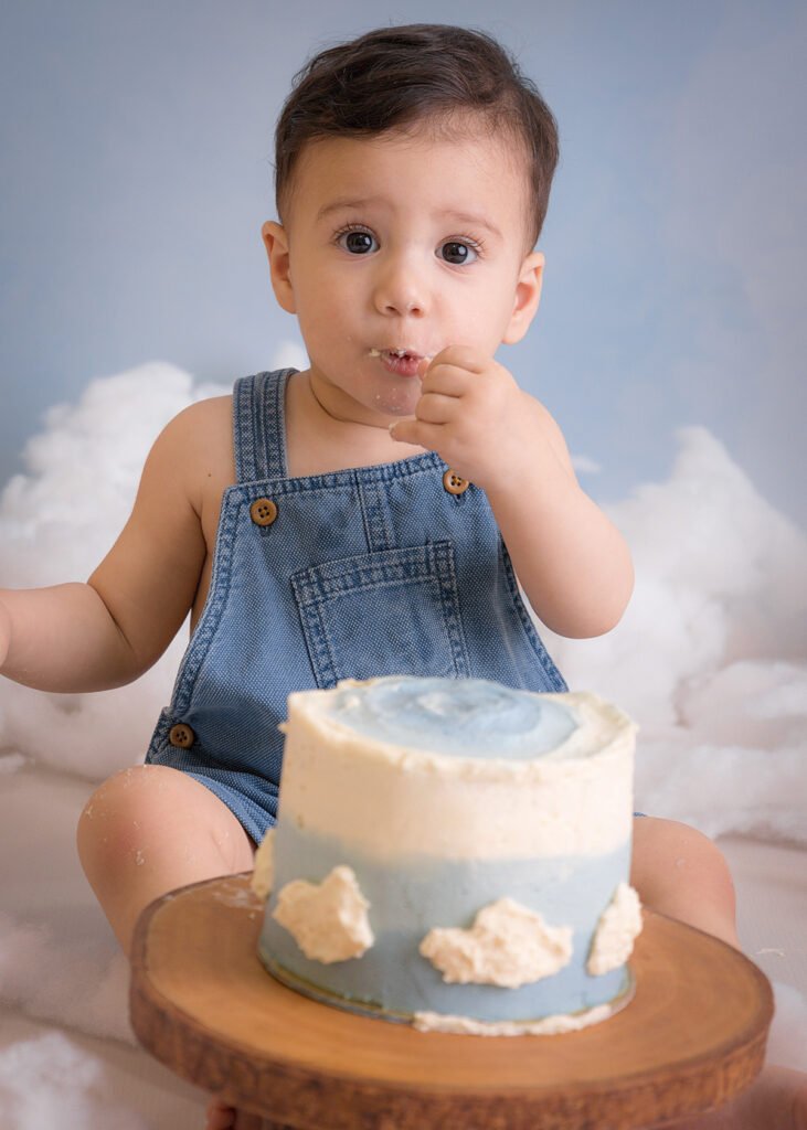 one year old first birthday cake smash baby toddler hot air balloon setup clouds blue sky photography photoshoot photo session