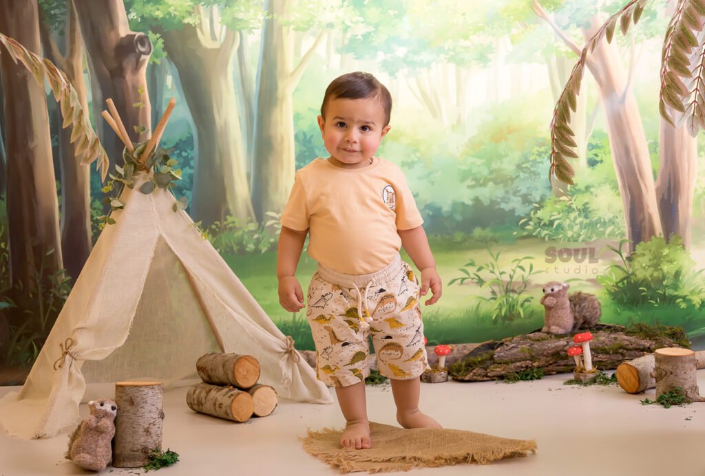 camping forest trees trunks teepee tent baby boy girl sitter squirrels mushrooms moss nature