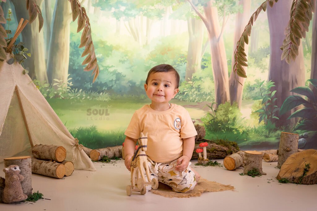 camping forest trees trunks teepee tent baby boy girl sitter squirrels mushrooms moss nature