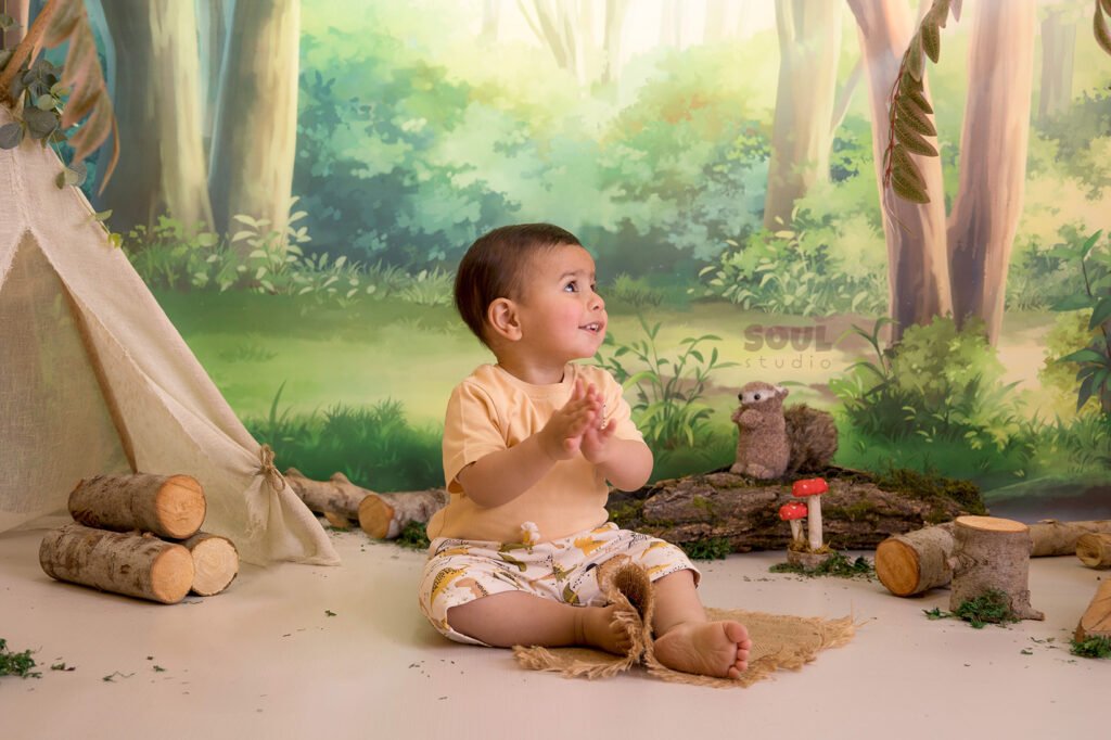 camping forest trees trunks teepee tent baby boy girl sitter squirrels mushrooms moss nature