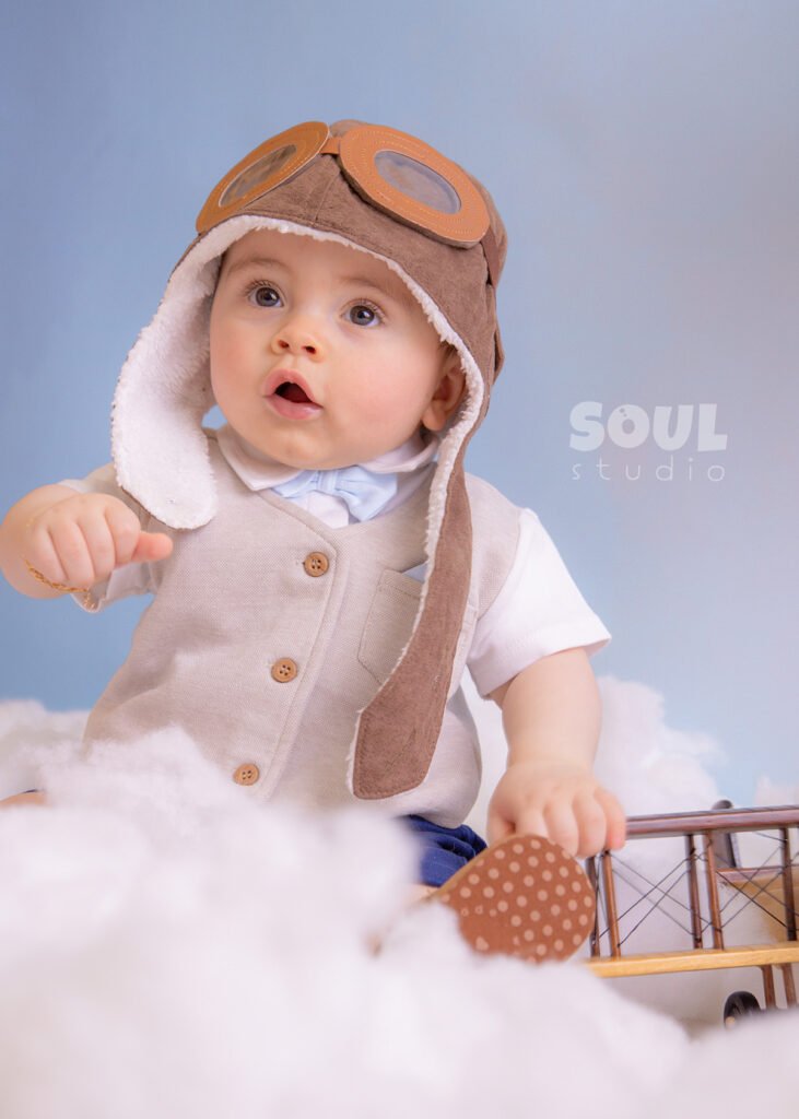 airplane baby sitter sky clouds 1 year old aviator hat pilot blue boy