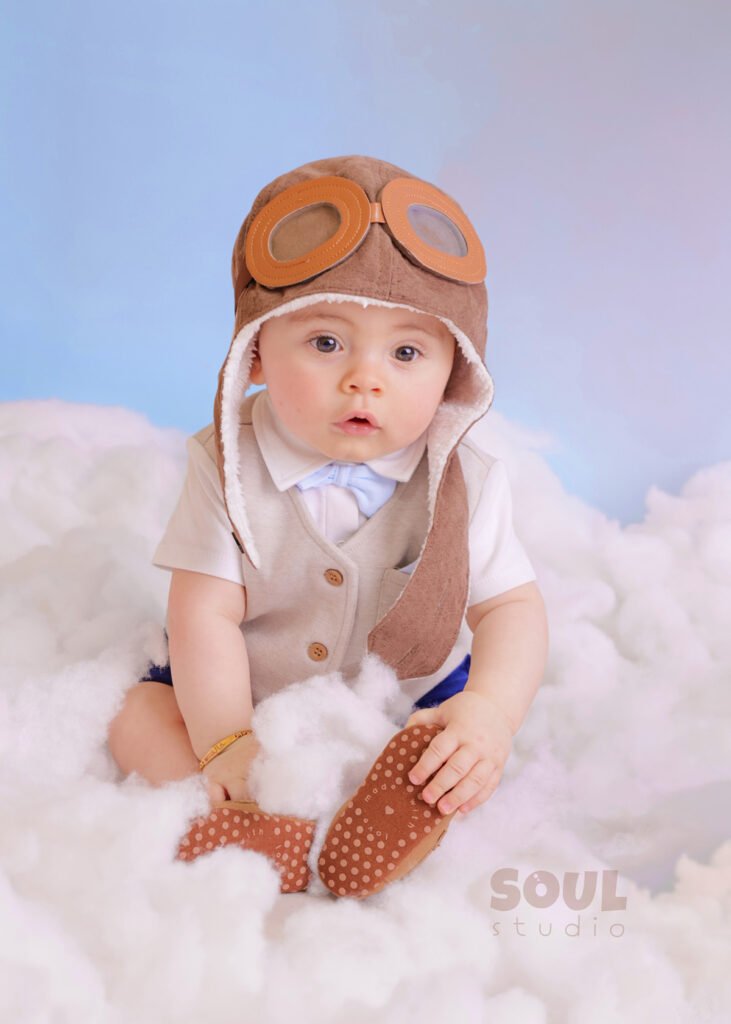 airplane baby sitter sky clouds 1 year old aviator hat pilot blue boy