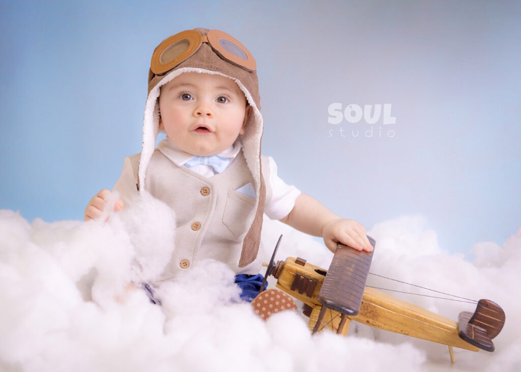 airplane baby sitter sky clouds 1 year old aviator hat pilot blue boy