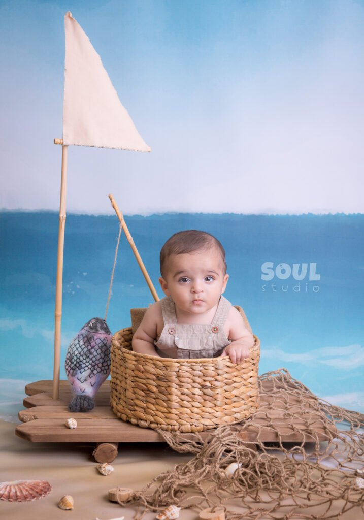 fishing sea floating boat baby boy sitter non-sitter beach starfish seashells blue sky ocean sailor setup fish rod