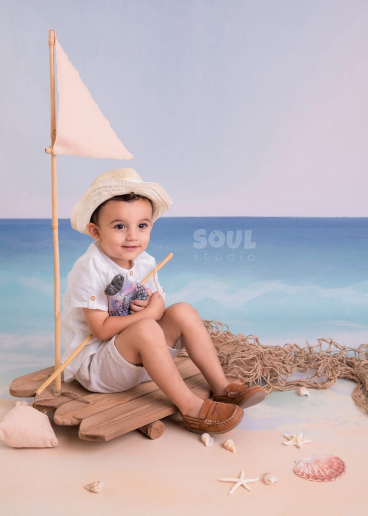 fishing sea floating boat baby boy sitter non-sitter beach starfish seashells blue sky ocean sailor setup fish rod