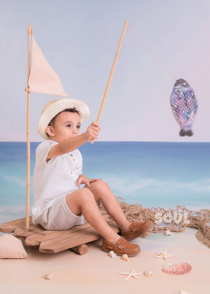 fishing sea floating boat baby boy sitter non-sitter beach starfish seashells blue sky ocean sailor setup fish rod