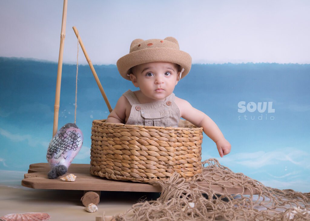 fishing sea floating boat baby boy sitter non-sitter beach starfish seashells blue sky ocean sailor setup fish rod