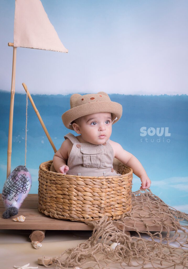 fishing sea floating boat baby boy sitter non-sitter beach starfish seashells blue sky ocean sailor setup fish rod