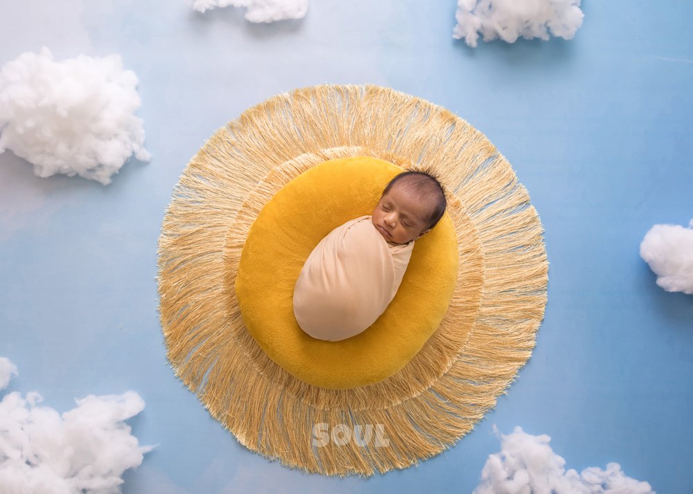 Newborn baby posed in a handcrafted setup at Soul Studio
