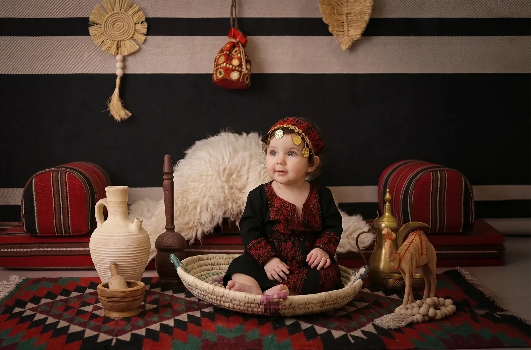 Baby girl in a traditional embroidered Jordanian thobe, Bedouin heritage theme at Soul Studio