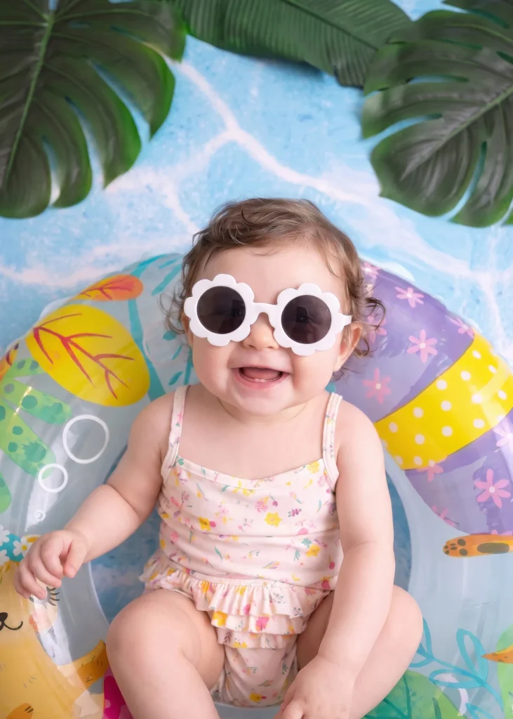 Baby portrait with playful swimming pool props at a themed studio photoshoot in Amman