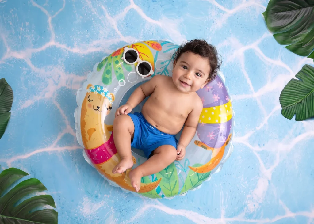 Summer swimming pool baby photoshoot with soft blue styling at Soul Studio, Dabouq