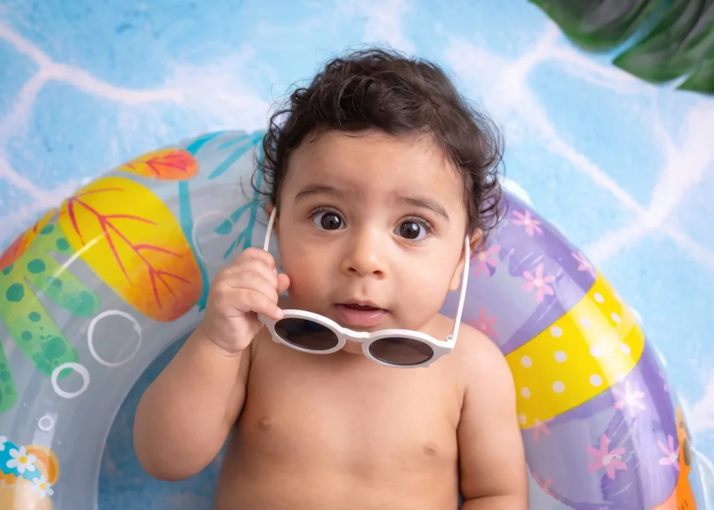 Bright editorial baby portrait from a pool-themed photography session in Amman